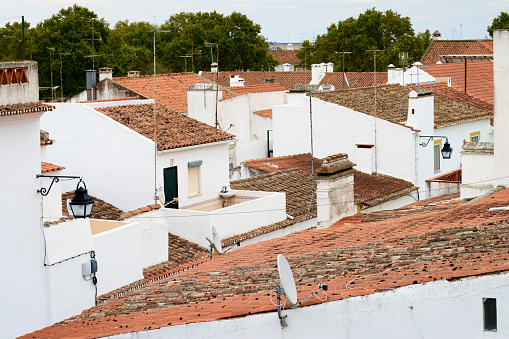 A view over the terracotta rooftops of whitewashed houses of the city of Evora in the Alentejo Province of Portugal.