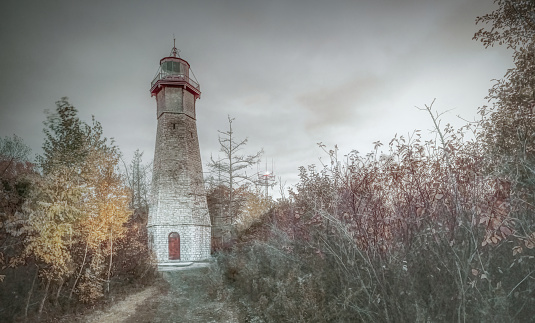 Toronto, Ontario, Canada - November 07, 2023:  Established in 1808, Gibraltar Point Lighthouse is the oldest lighthouse in the Great Lakes system.   Built on the Toronto Islands just off the mainland of downtown Toronto, it remains today as a tourist attraction and as a heritage site.   It is no longer functional.   It has though gained a reputation for being haunted after its original operator/keeper was murdered there in 1815.