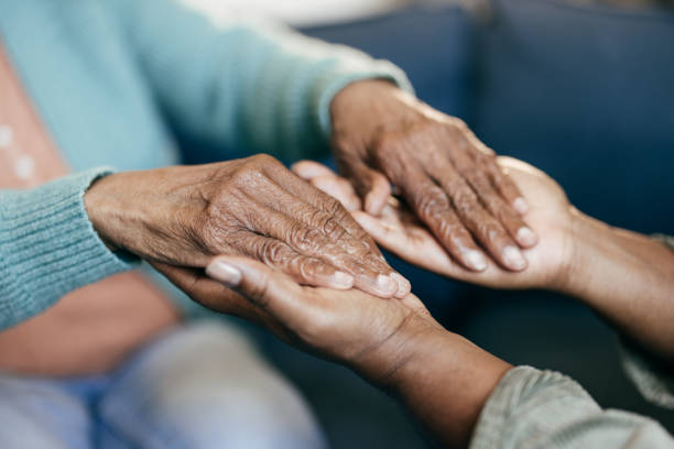 istock Young woman holding elderly hands 1801206392