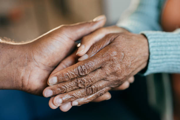 istock Young woman holding elderly hands 1801206396