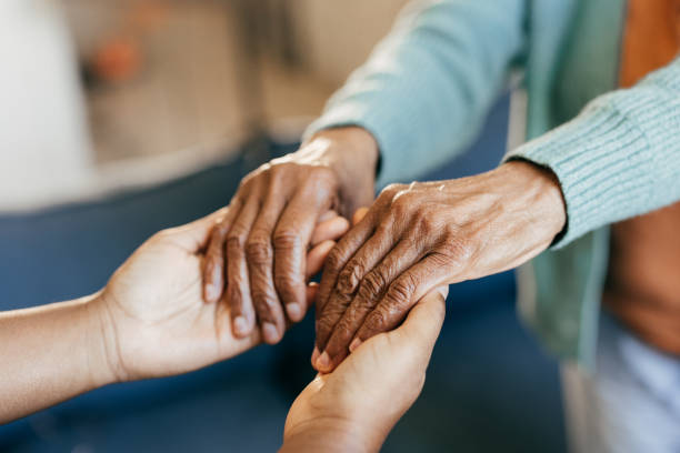 istock Young woman holding elderly hands 1801206397