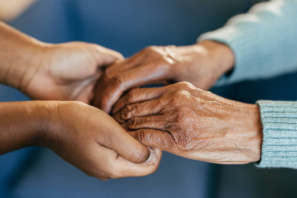 istock Young woman holding elderly hands 1801206399