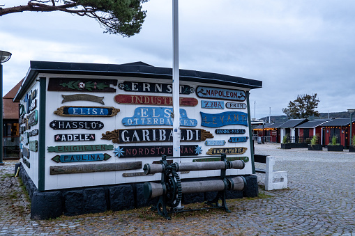 Bastad, Sweden Oct 28, 2023 Old plaques with boat names grace a small boat house in the harbour.