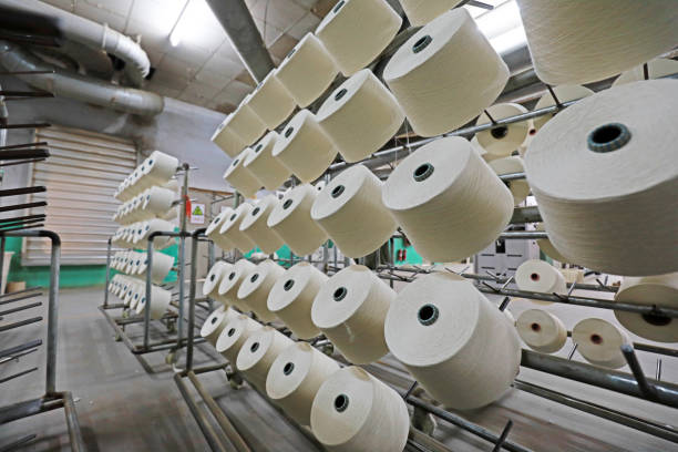 istock Cotton yarn piled up waiting to be packed in a spinning mill 1801216352
