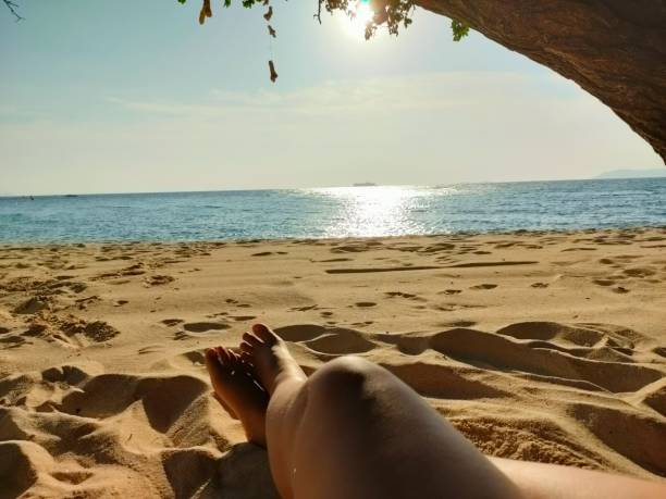 istock Woman's legs on the beach 1801219499