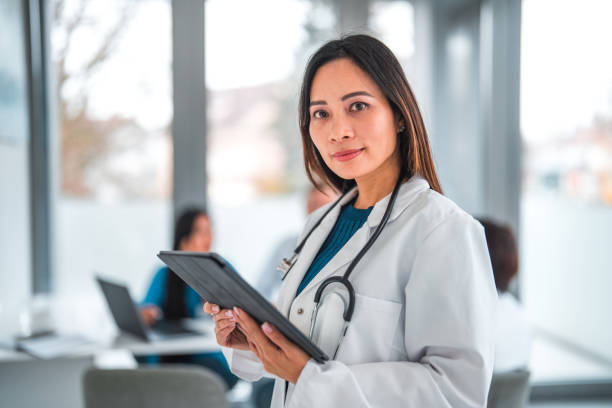 istock Good Looking Asian Female Healthcare Worker Using A Digital Tablet 1801224461