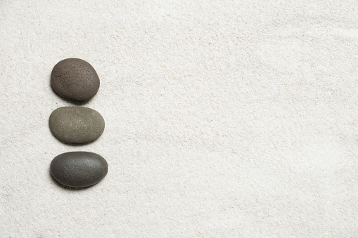 Top view of three stones resting on sandstone balance concept, Japanese Zen garden.