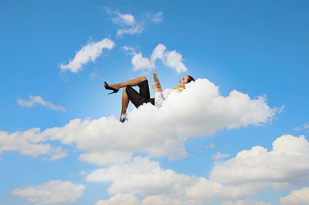 istock Businesswoman lying on clouds 180125154