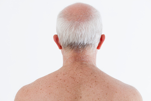 Back view of a senior man, showcasing natural aging and time's effects