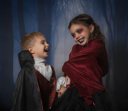2 little children disguised as vampires