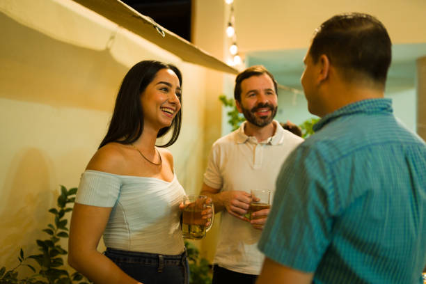 istock Attractive woman talking with her happy friends drinking beer 1801320689