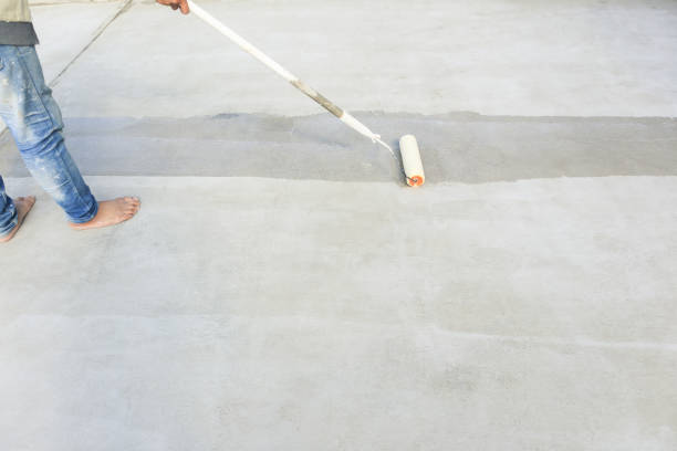 istock Worker to skim coat surface of concrete pavement floor or slab. 1801341991