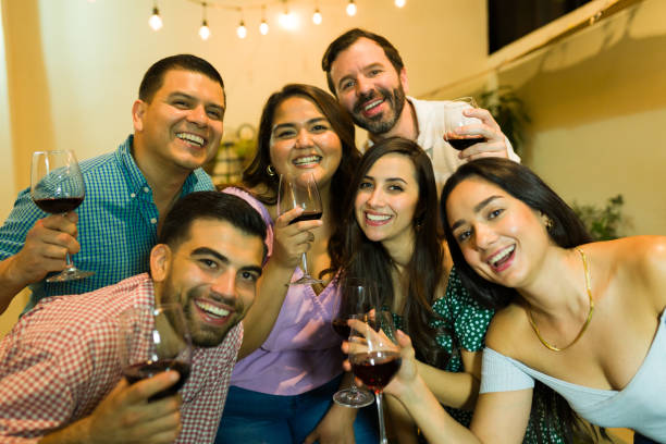 istock Attractive group of happy friends drinking wine and having fun 1801350361