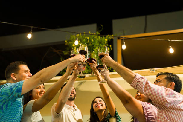 istock Cheerful smiling friends celebrating drinking wine 1801351941