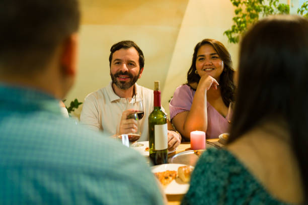 istock Happy couple talking with friends during a fun dinner 1801354080