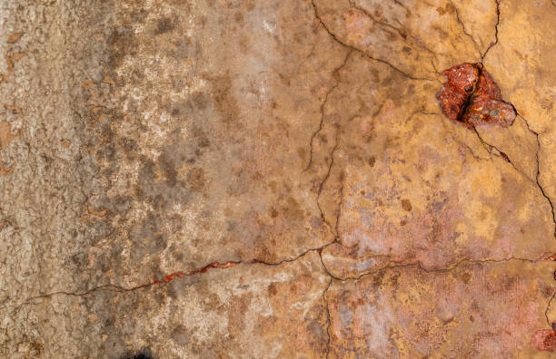 istock Close up of aged concrete wall with cracks 1801455476