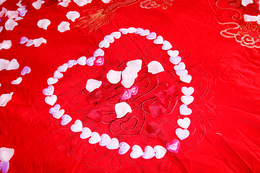 Red heart-shaped pattern on quilt with cotton wadding