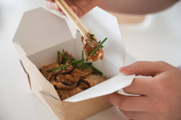 istock unrecognizable man eating poke bowl with ducke and rice 1801519069