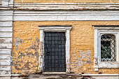 Antique iron gates in the old brick wall.