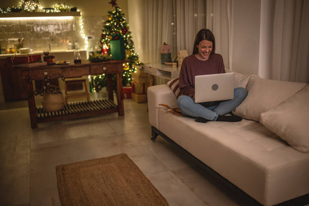 istock Young woman using laptop on a New Year's eve. 1801560692