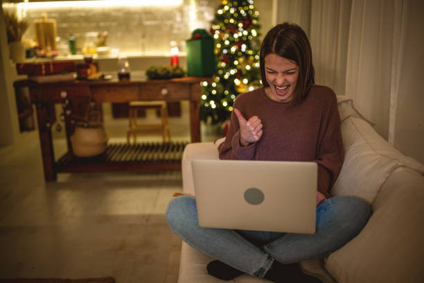 istock Young woman using laptop on a New Year's eve. 1801563784