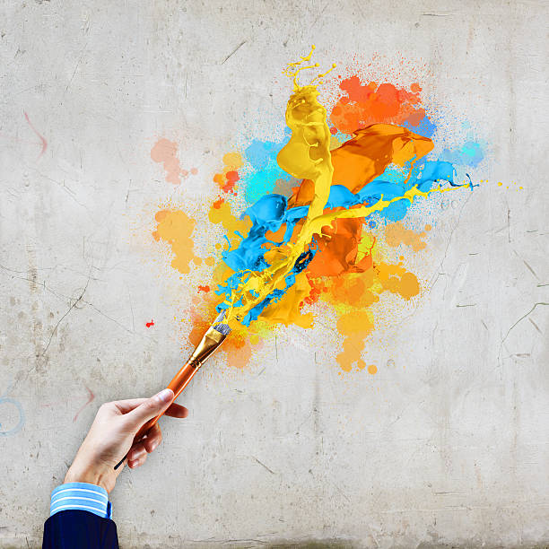 istock Human hand holding paint brush 180157947