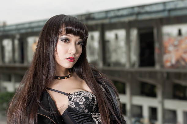 istock Asian woman in emo goth clothes at an abandoned building 1801590331
