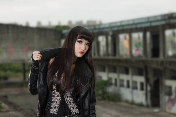 istock Asian woman in emo goth clothes at an abandoned building 1801590854