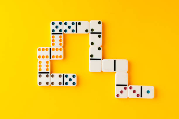 istock Domino tiles on yellow background studio shot 1801601245