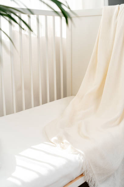 istock Soft cotton blanket hanging on baby's bed 1801621764