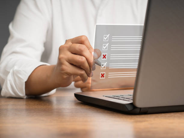 Businessman is making a checkmark and a cross symbol on a document management system or DMS on a virtual screen