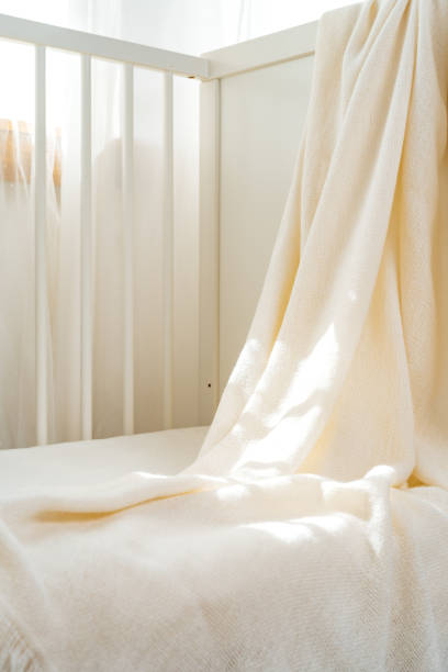 istock Soft cotton blanket hanging on baby's bed 1801629775