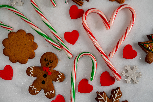 candy canes put like hearth love christmas cookies gingerbread are on white background horizontal christmas still