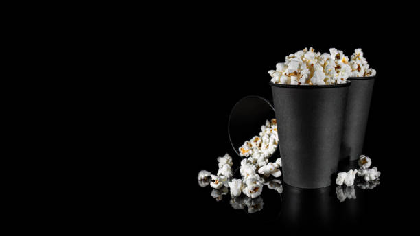 istock Two black standing paper cups with popcorn 1801643525