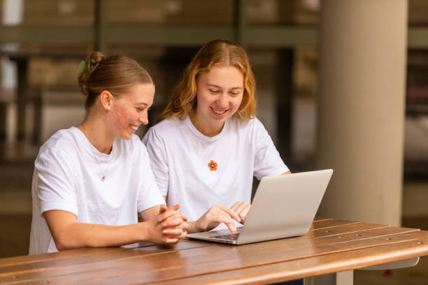 istock Young women university students studying together on campus 1801652962