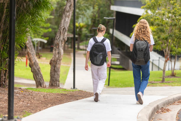 istock Young women university students walking together on campus 1801652975