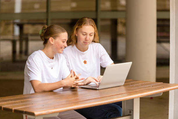 istock Young women university students studying together on campus 1801658139