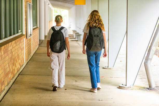 istock Young women university students walking together on campus 1801658140
