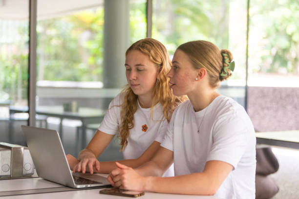 istock Young women university students studying together in a library 1801659687