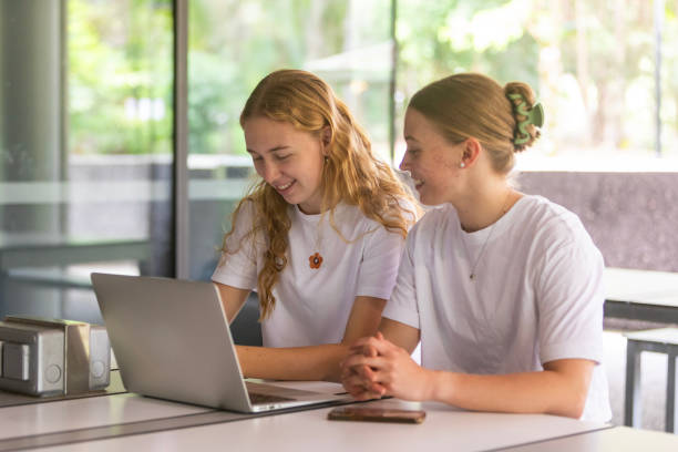 istock Young women university students studying together in a library 1801659688
