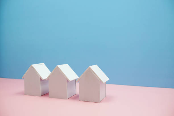 istock Group of House Model isolated with space for copy on blue and pink background 1801662290
