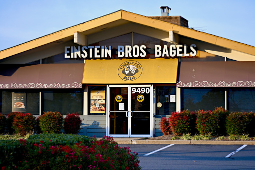 Fairfax, Virginia (USA) - November 15, 2023: The entrance of an Einstein Brothers Bagels restaurant in the City of Fairfax is bathed in afternoon sun.