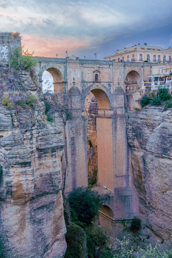 view of the new bridge over the cliff of ronda,malaga,spain with a sunset with a dramatic colorful sky