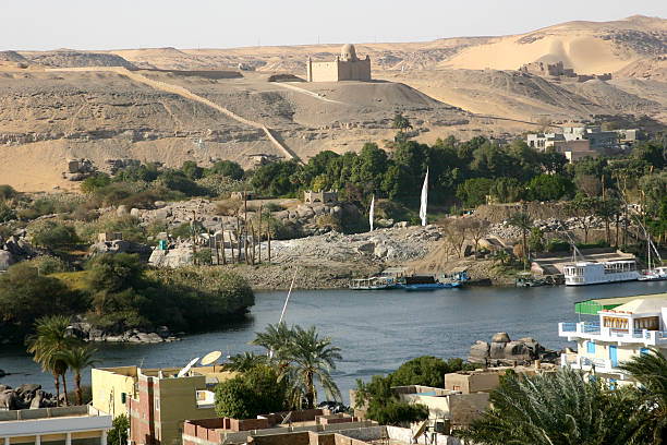 View in Aswan A View of the Nile River in Aswan with the Mausoleum of the Aga Khan in the background. aga khan iv stock pictures, royalty-free photos & images