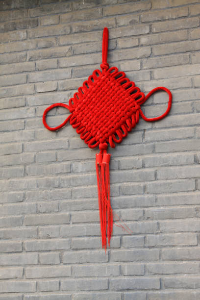 istock yellow Chinese knot on the red wall 1801716483