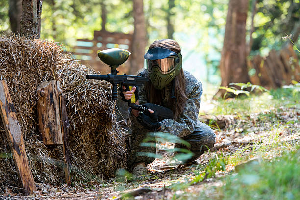 Sniper Aiming Gun paintball sport player in protective uniform and mask aiming gun before shooting paintballing stock pictures, royalty-free photos & images