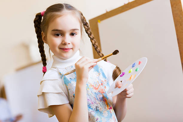 istock Cute girl painting 180175205