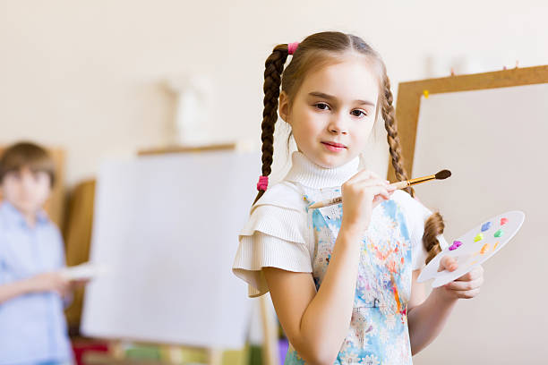 istock Cute girl painting 180175284