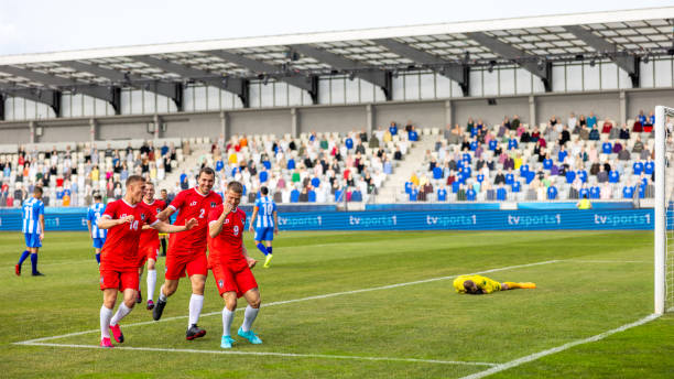 istock Soccer players team scoring a goal 1801794386