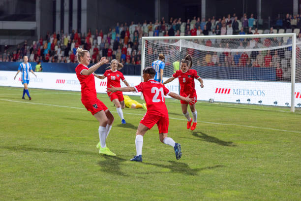 istock Soccer players hugging after scoring a goal 1801794393